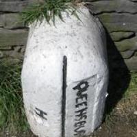 Half-buried boundary stone